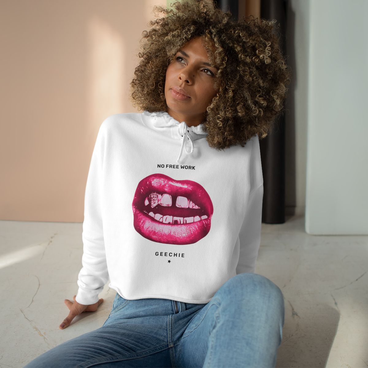 Model wearing the white GEECHIE No Free Work cropped hoodie